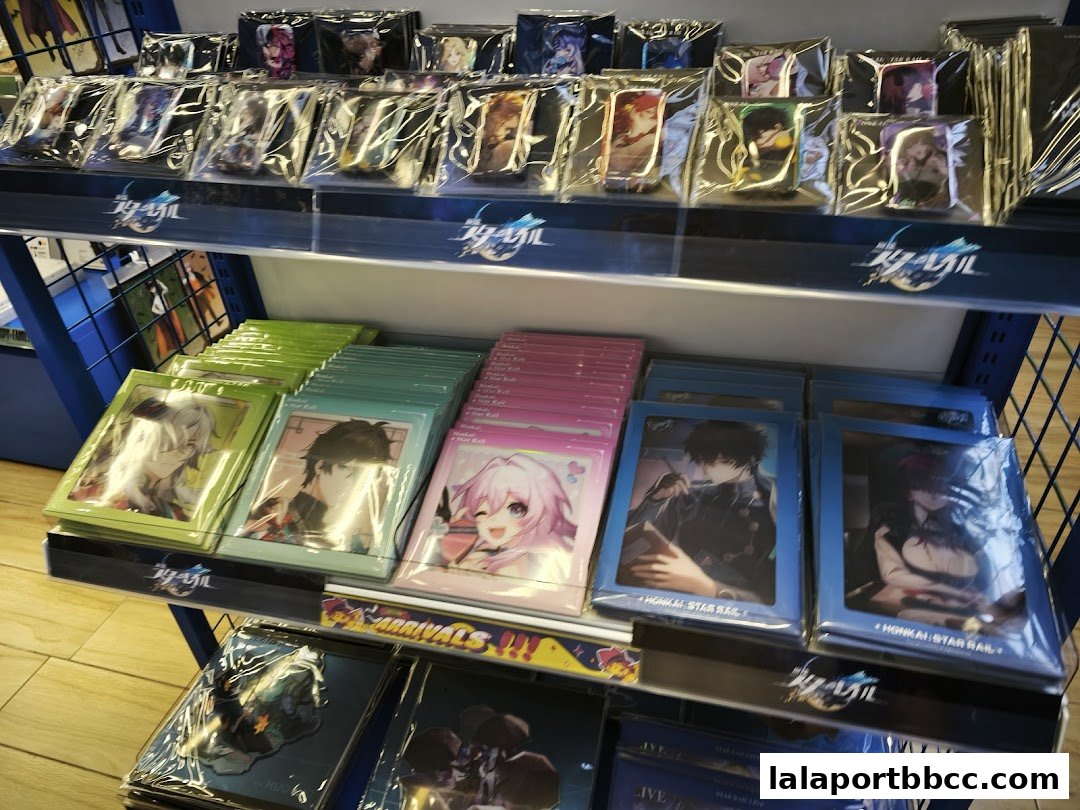 Shelves stocked with anime merchandise, including character cards and keychains.