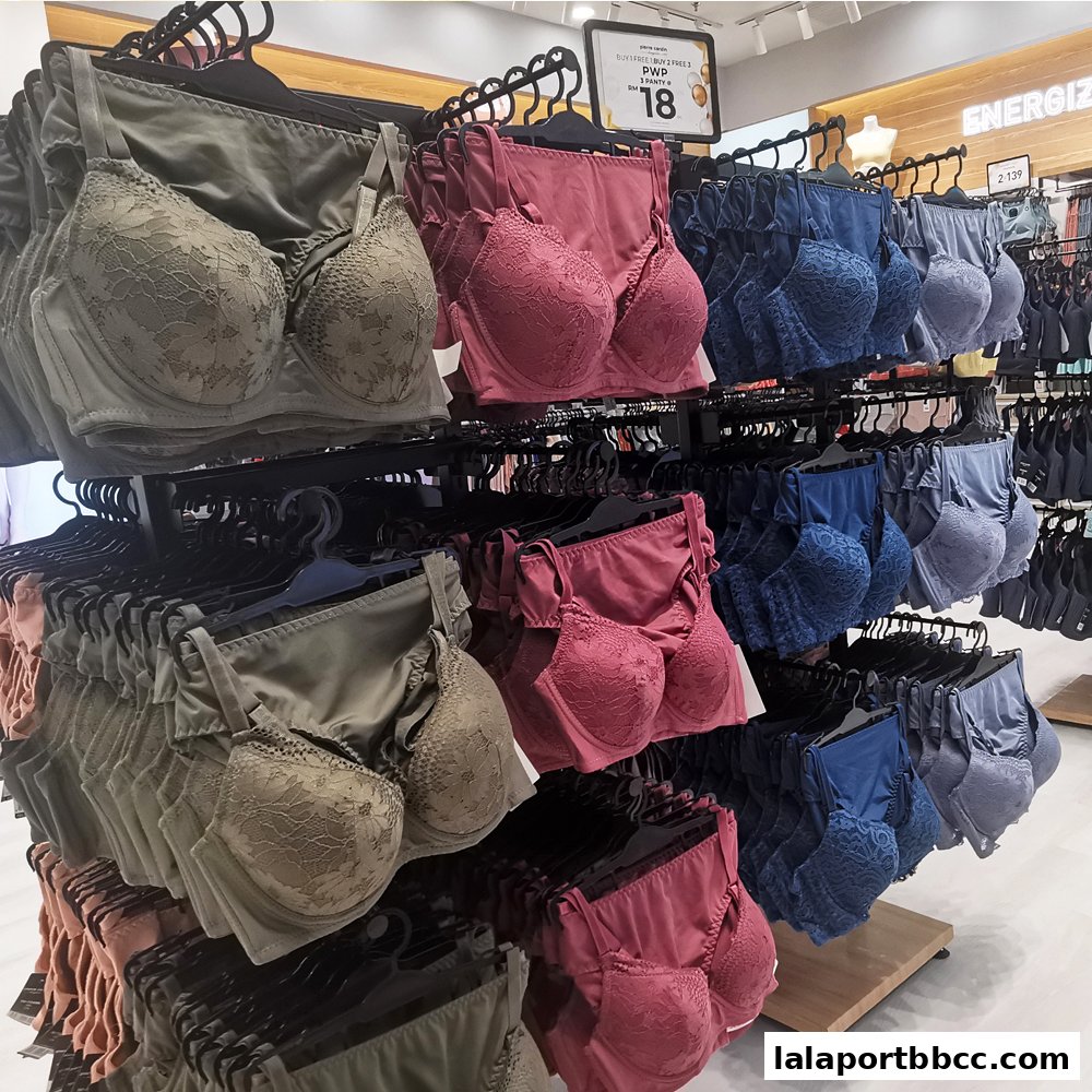 Lingerie sets including bras and panties displayed on racks in various colors.