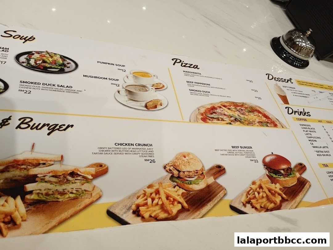 A menu featuring soups, pizzas, burgers, desserts, and drinks with prices.
