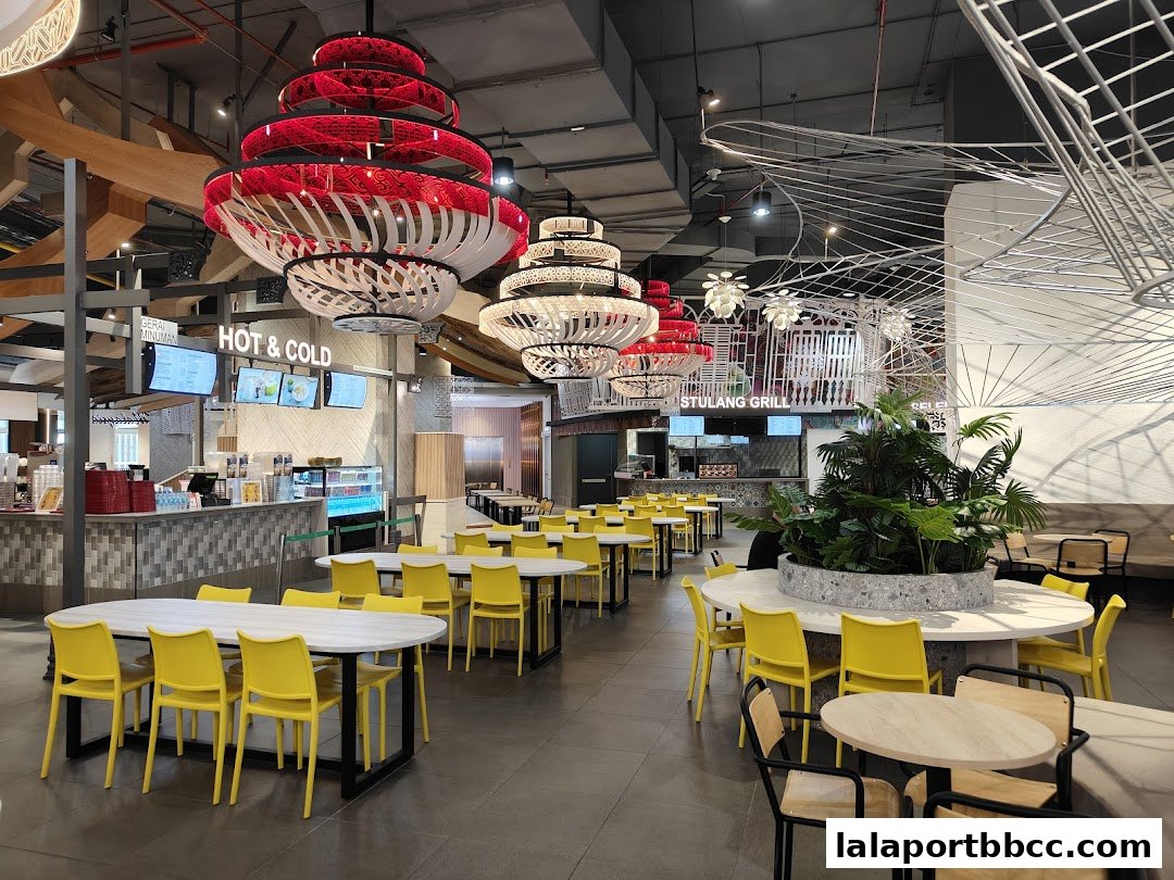 Modern food court with bright yellow chairs and unique layered pendant lights.