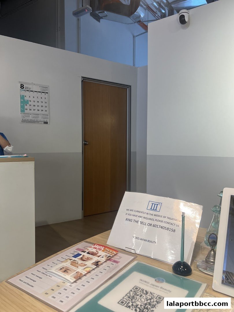 A reception desk with a menu, a sign, and a QR code for Ikuko Japan Beauty.