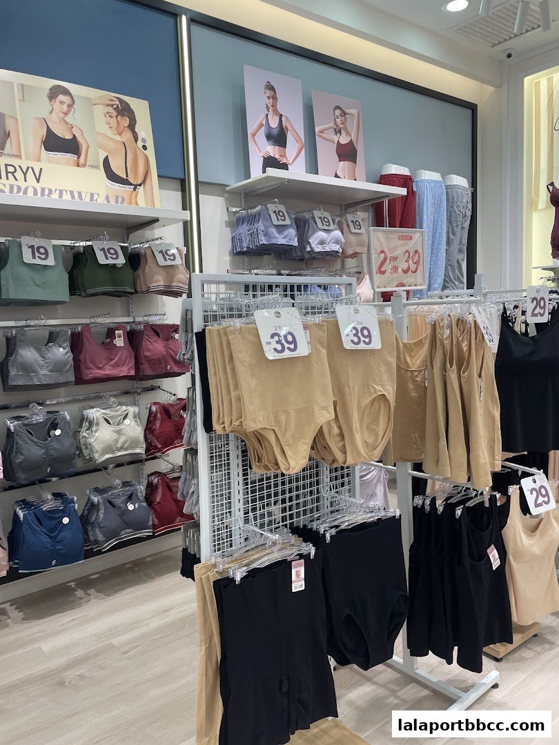 A well-organized display of women's sportswear and undergarments in a retail store.