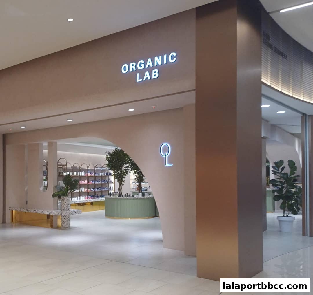 The entrance to Organic Lab MY, a modern shop with shelves of products and decorative plants.