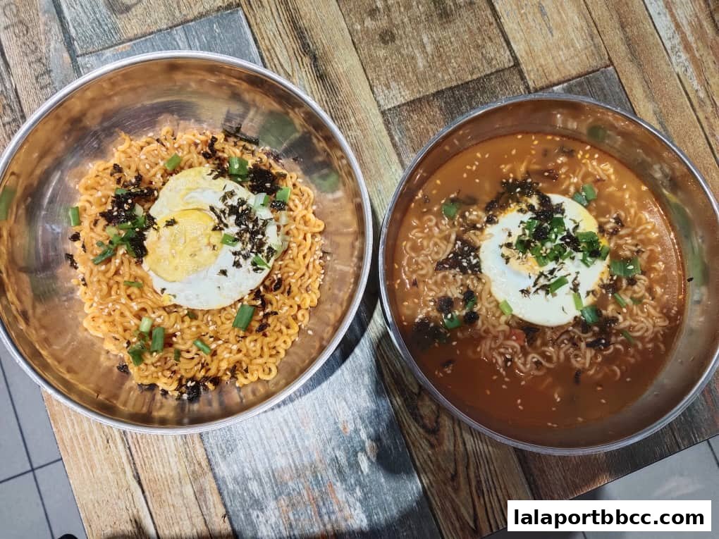 Two bowls of Korean instant noodles, one dry and one in broth, topped with fried egg and seaweed.