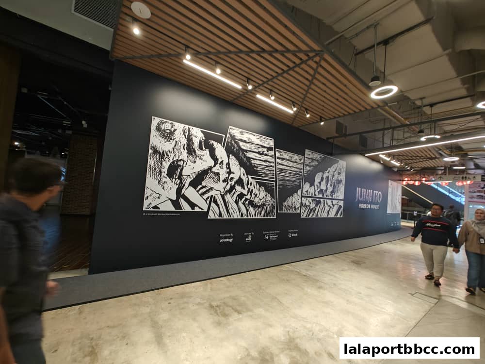 The Junji Ito Horror House features a striking black wall with horror-themed artwork and the shop's name.