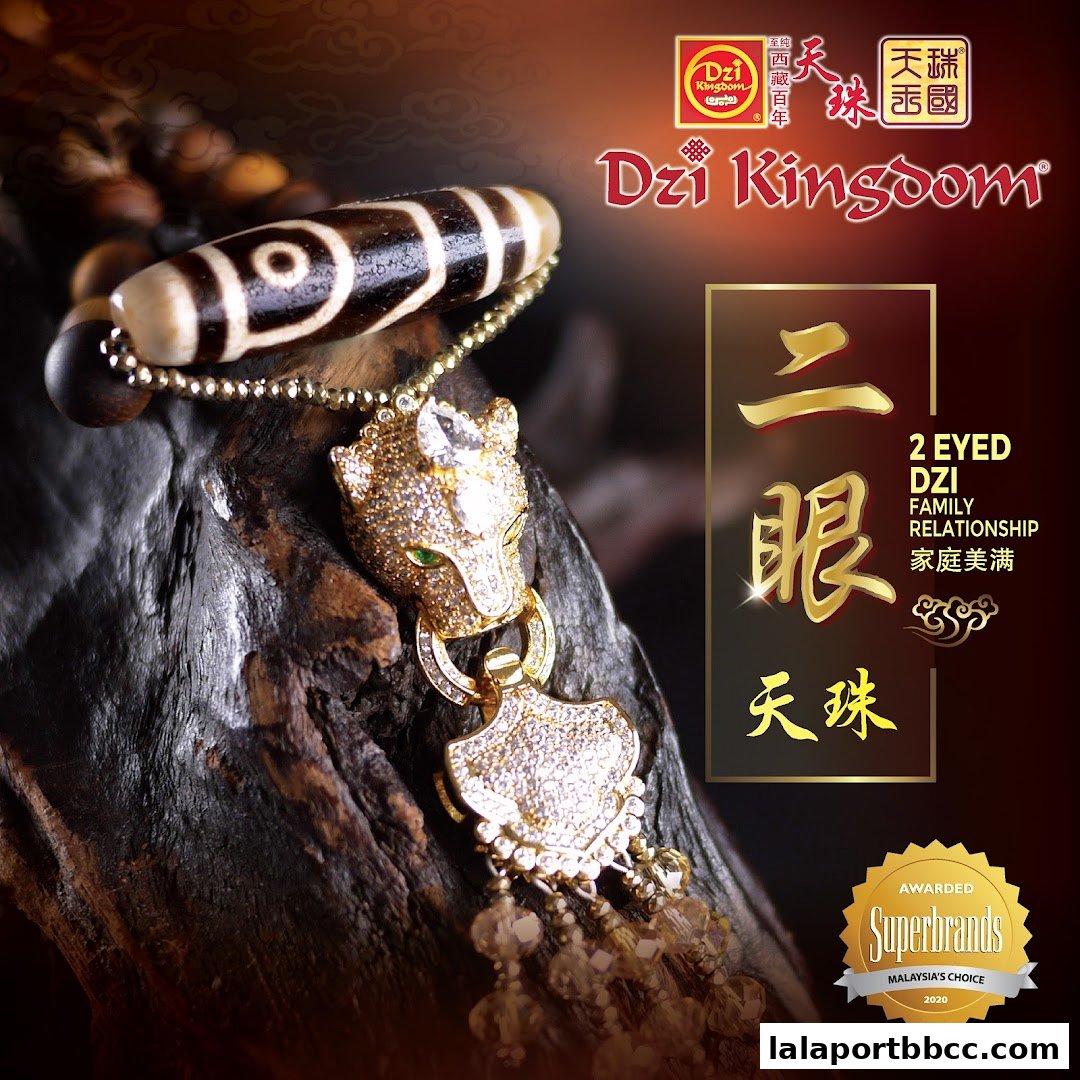 A close-up of a Dzi bead bracelet with a jeweled pendant, promoting Dzi Kingdom.