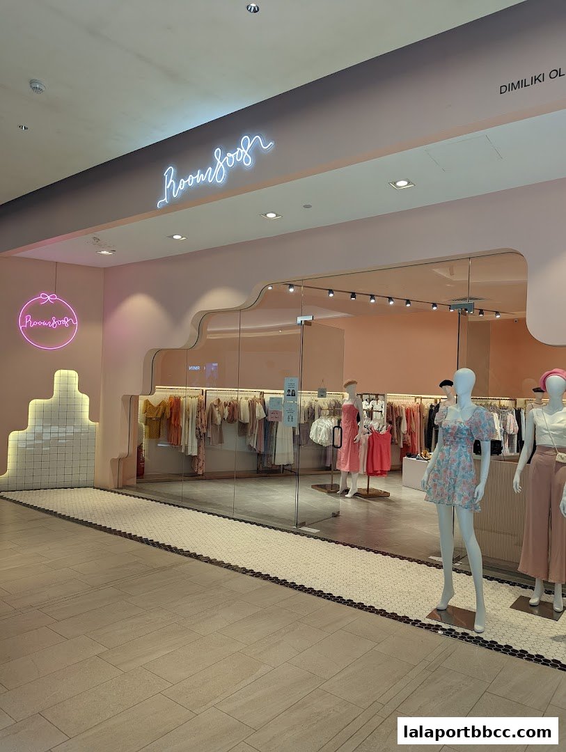 The entrance of Room 8008 LaLaport, a clothing store with mannequins and apparel displayed.