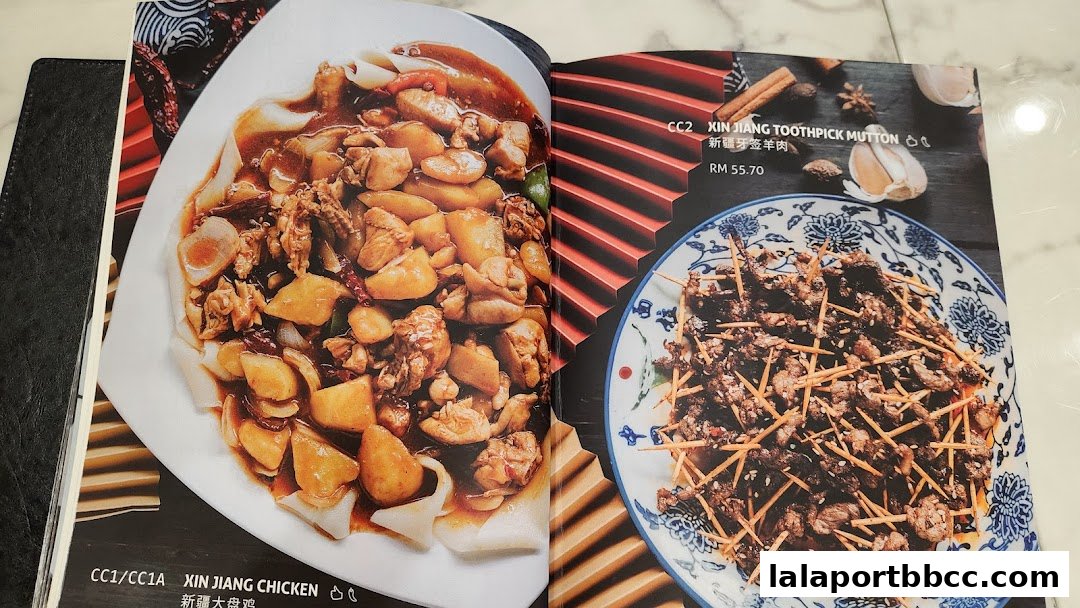 A menu showcasing two Xinjiang dishes: Xin Jiang Chicken and Xin Jiang Toothpick Mutton.