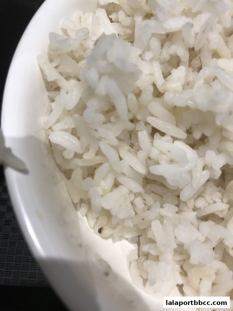 A close-up shot of a bowl filled with fluffy white rice.