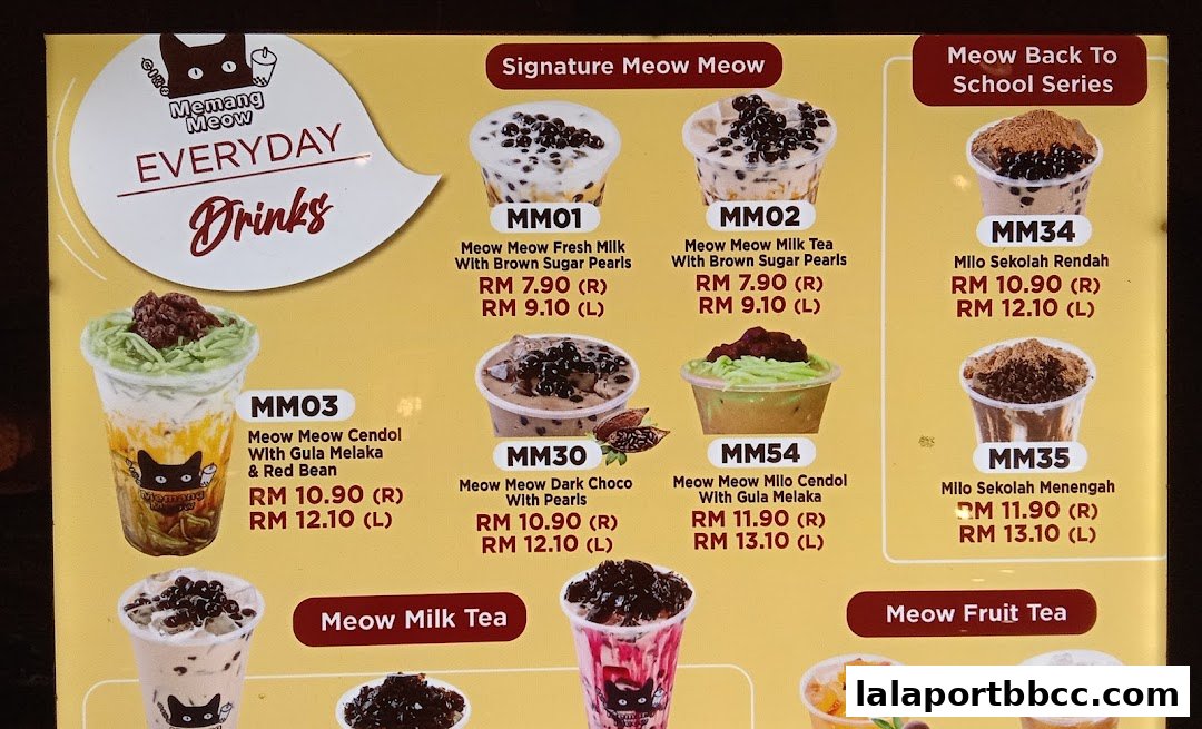 A menu board displaying various drinks from Memang Meow, featuring signature drinks and back-to-school specials.
