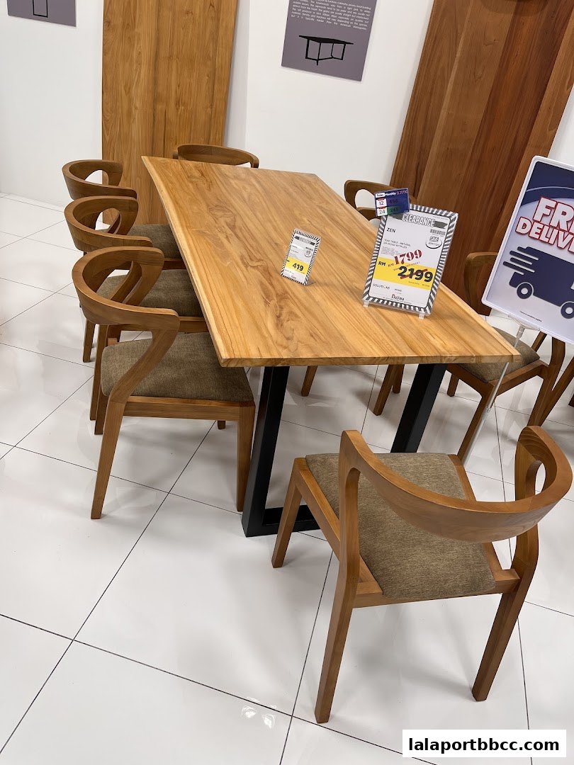 A wooden dining table with chairs, showcasing a modern furniture display.