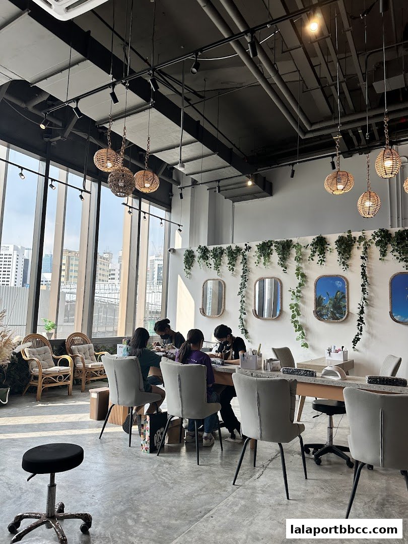 Interior of a modern nail salon with clients receiving manicures and pedicures.