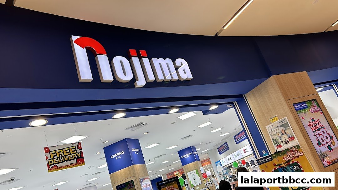 The Nojima electronics store entrance with prominent signage and promotional displays.