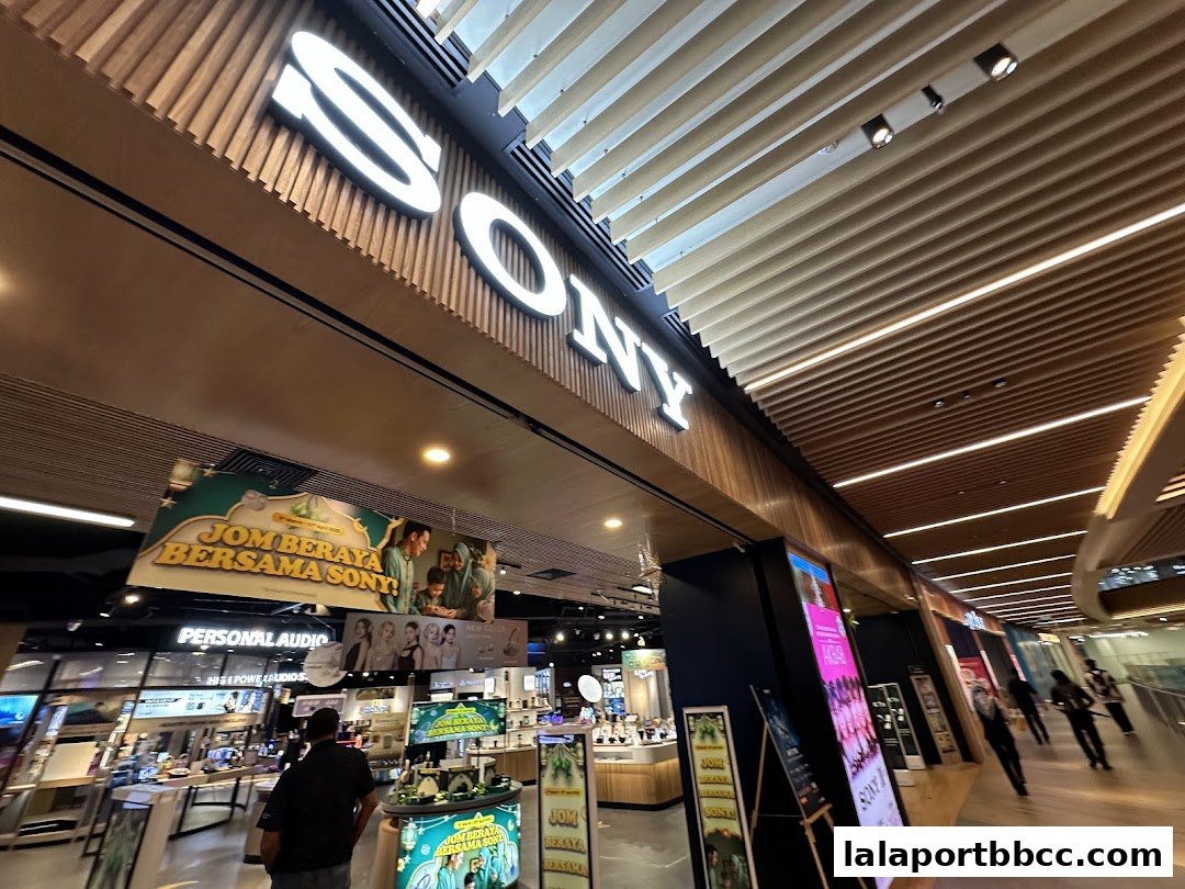 The entrance of a brightly lit Sony Store with large illuminated signage and product displays.