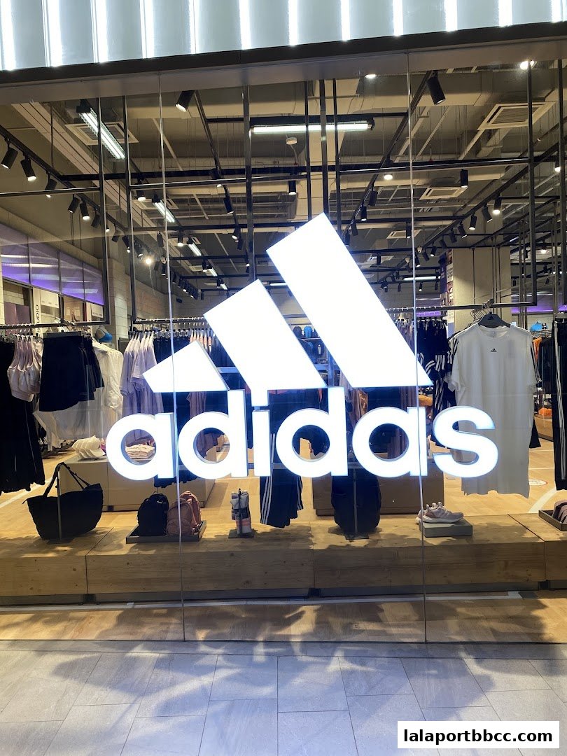The storefront of an Adidas Originals shop with clothing and accessories displayed.