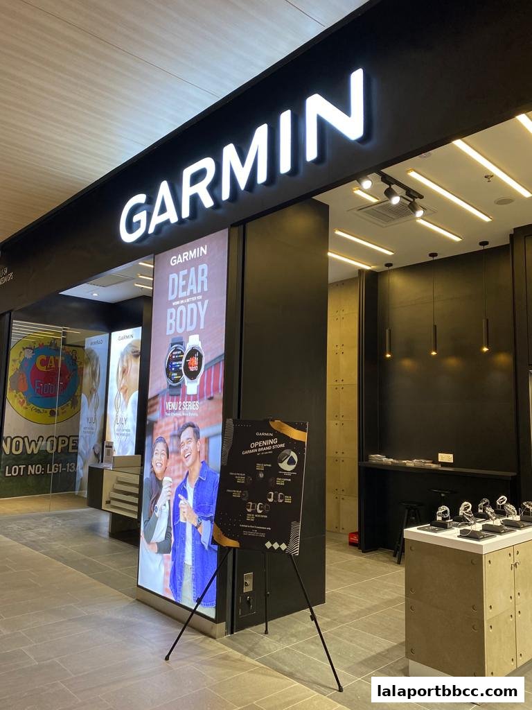The exterior of a Garmin store with a large illuminated sign and product displays.