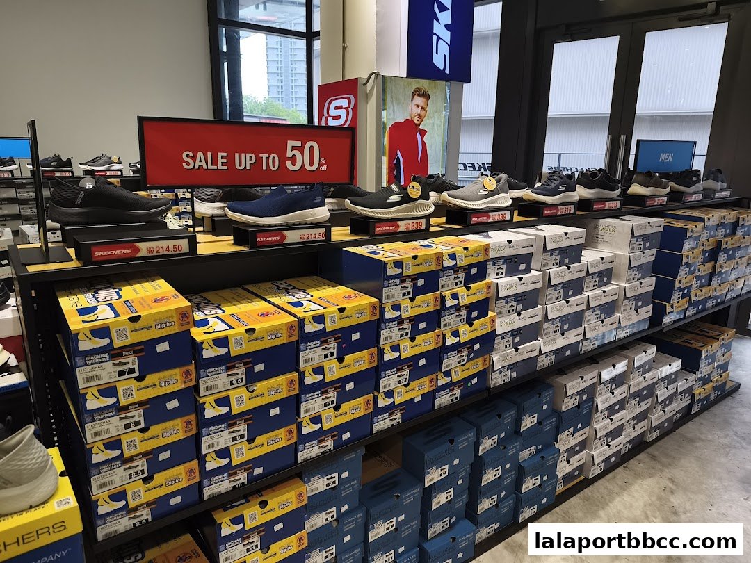 A Skechers store interior showcasing a sale on shoes with various models and stacked shoe boxes.
