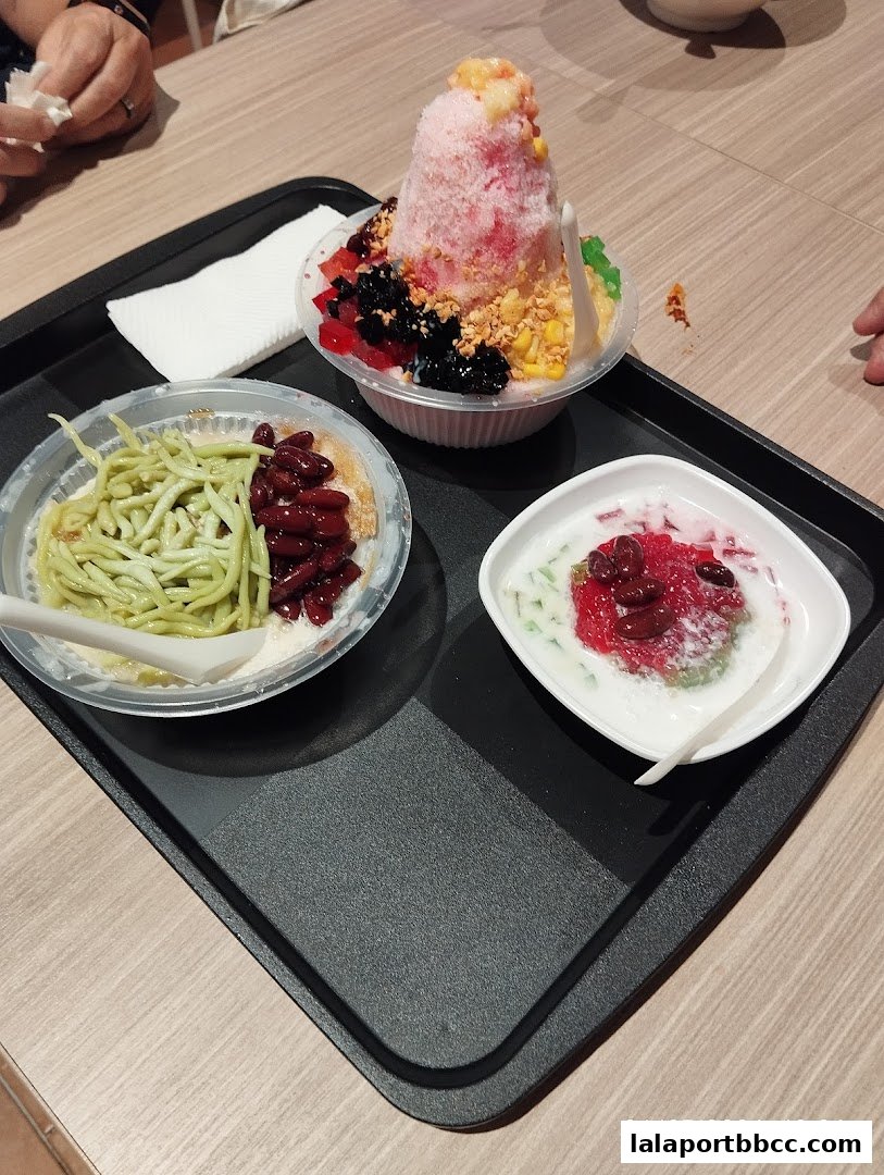 Three colorful and refreshing desserts served on a black tray.