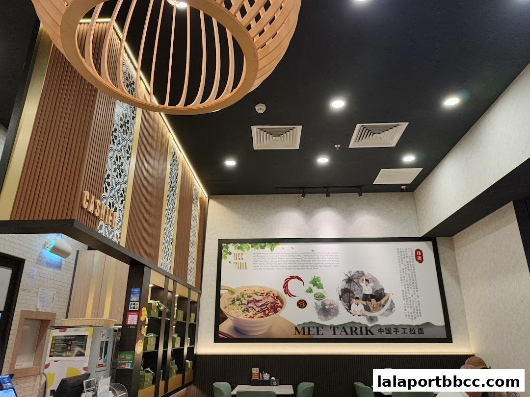 Interior view of Mee Tarik restaurant with a large promotional poster and seating area.