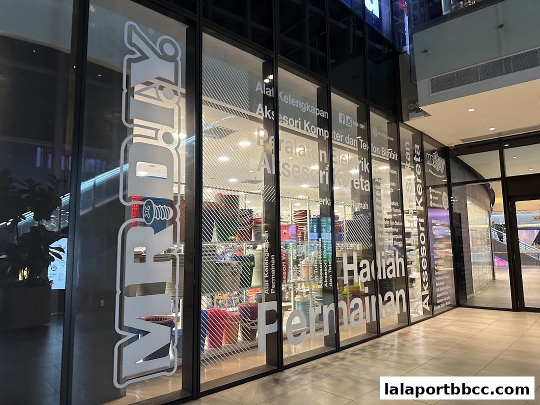 The exterior of a MR.DIY PLUS store with large glass windows displaying various products and store signage.