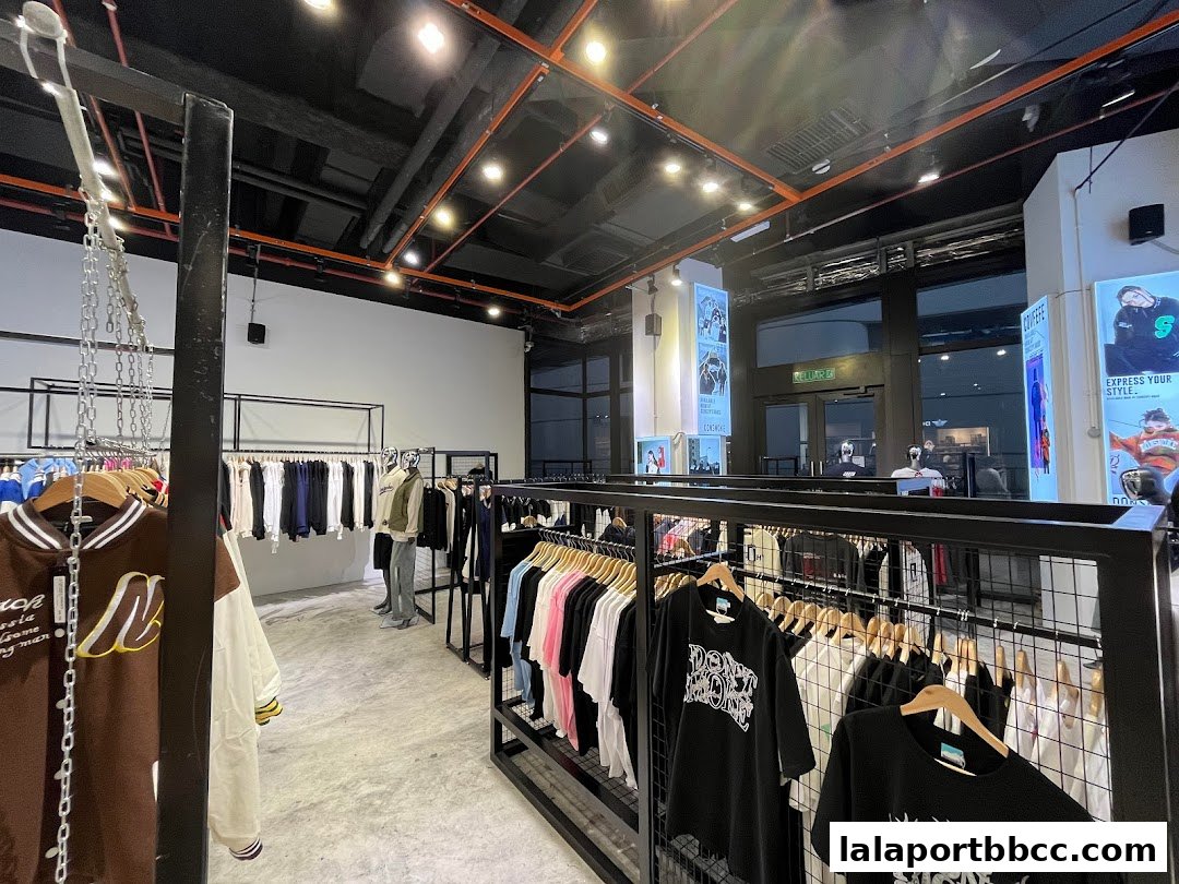 Interior view of a modern clothing store showcasing a variety of apparel on racks.