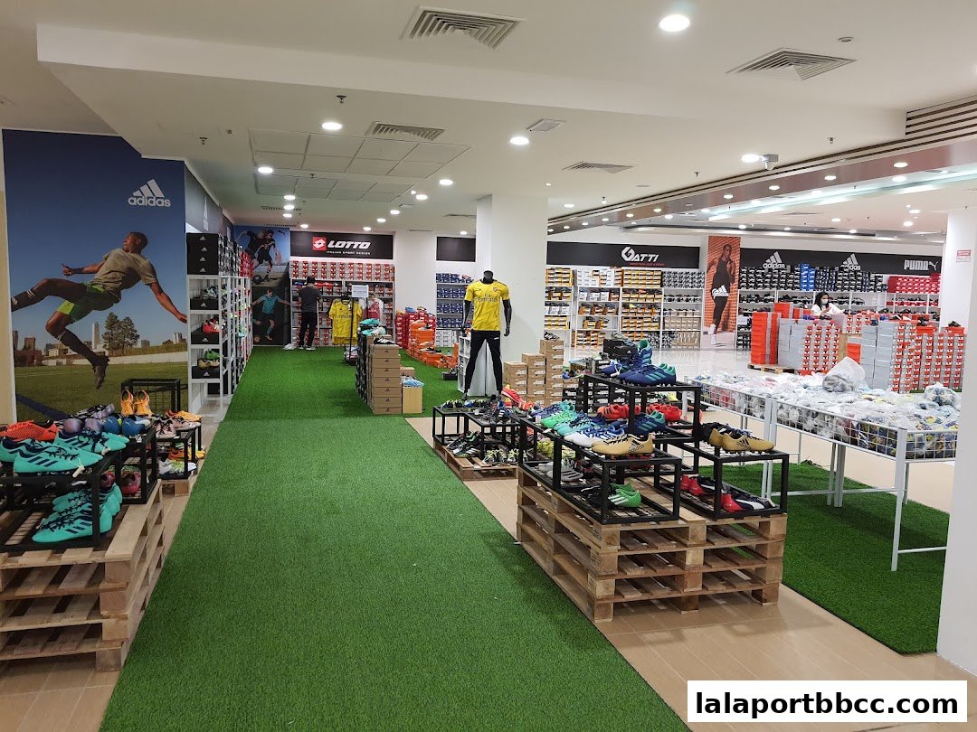 Interior view of a sports shoe store with displays of various athletic footwear and brand signage.