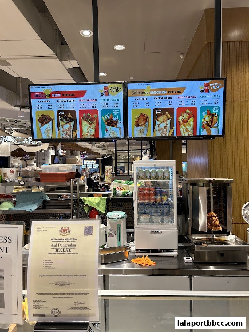 Digital menu boards displaying beef and chicken kebabs with prices and images.