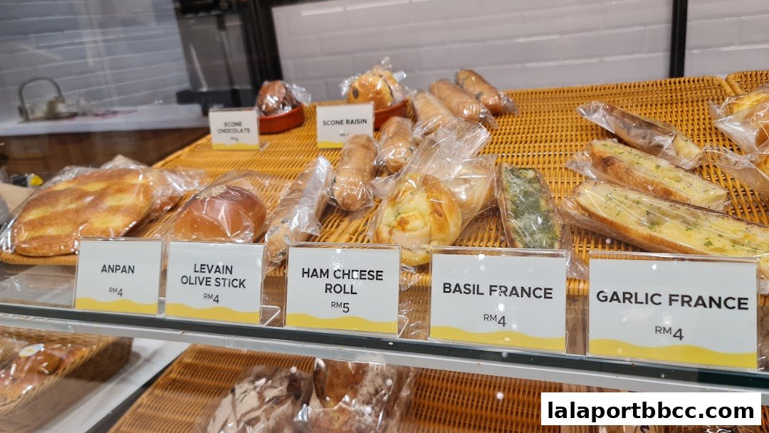 A display of freshly baked bread and pastries at Daily ButterJaya Grocer.