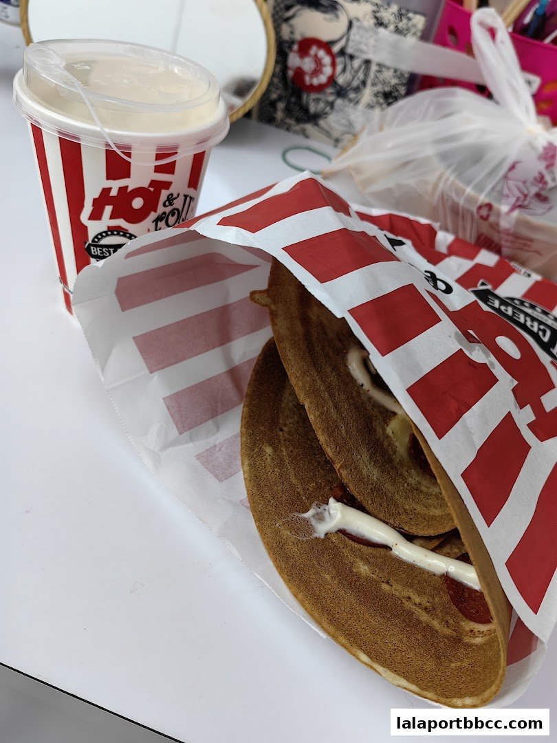 A close-up of a crepe and a drink from HotRoll Lalaport BBCC.