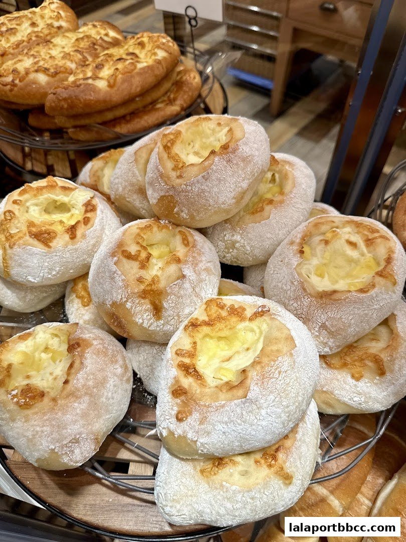 A close-up of freshly baked bread rolls filled with cheese.