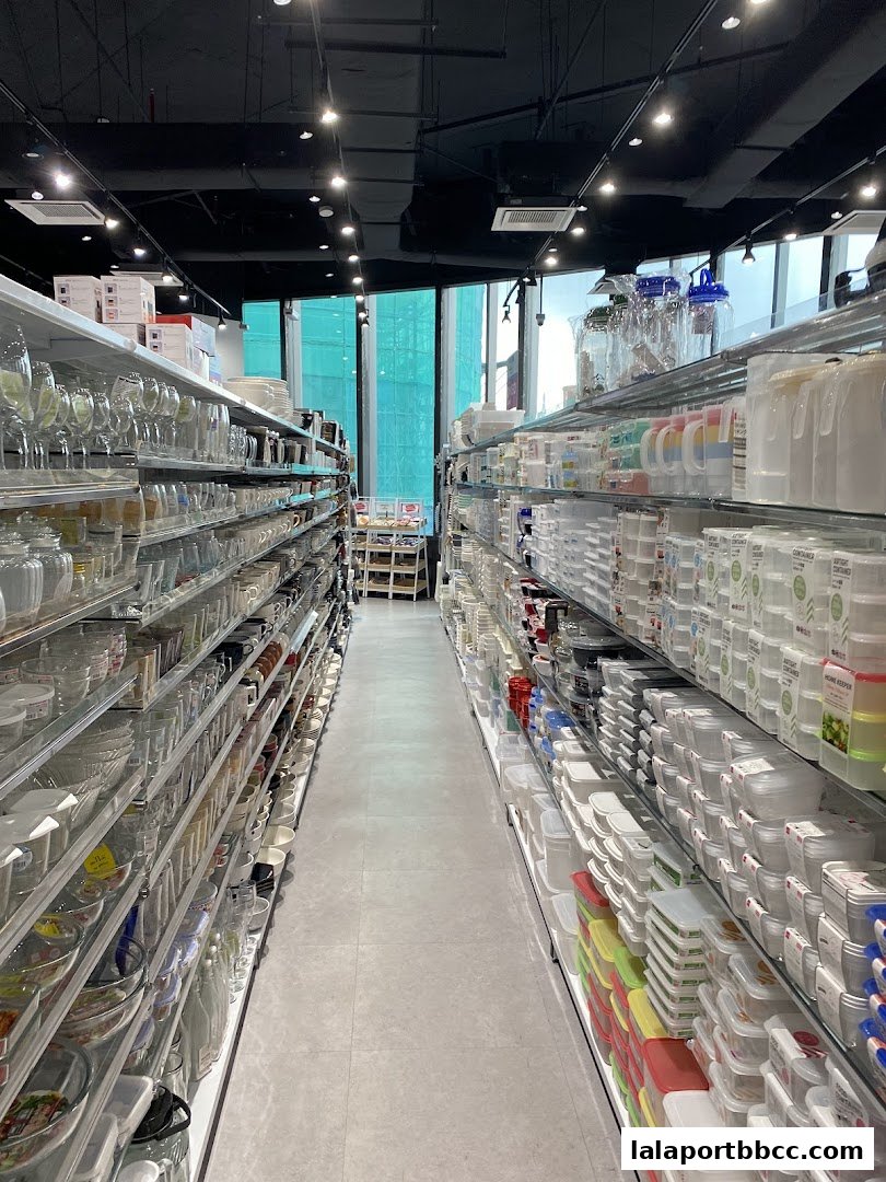 Aisle view of a Daiso store showcasing a wide variety of kitchenware and storage containers.