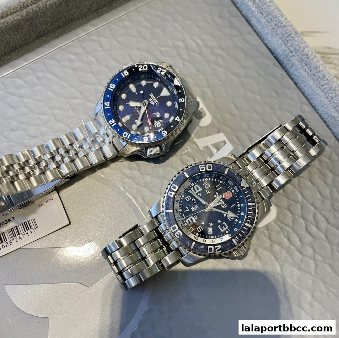 Two stylish men's watches, a Seiko and a Victorinox, are displayed on a textured surface.