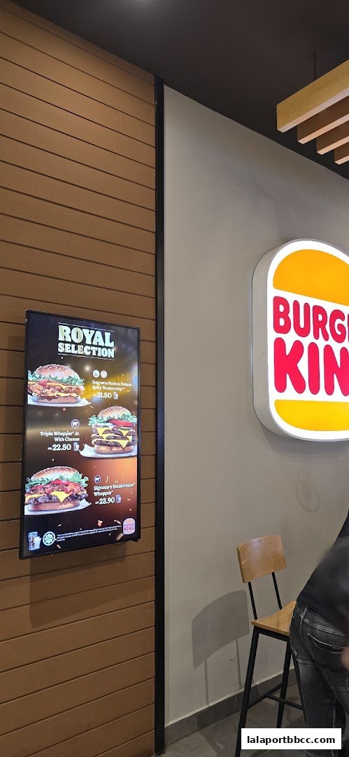 A digital menu board displaying Burger King's Royal Selection burgers with prices.