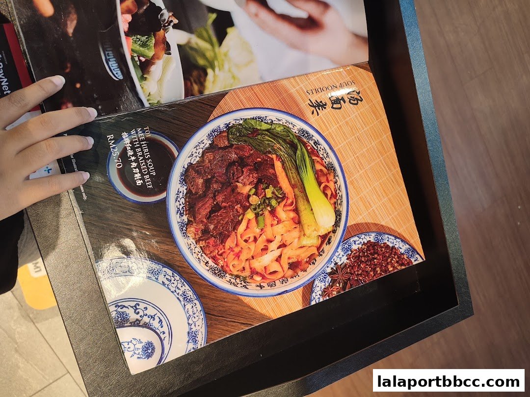 A menu featuring a bowl of beef soup noodles with braised beef and vegetables.