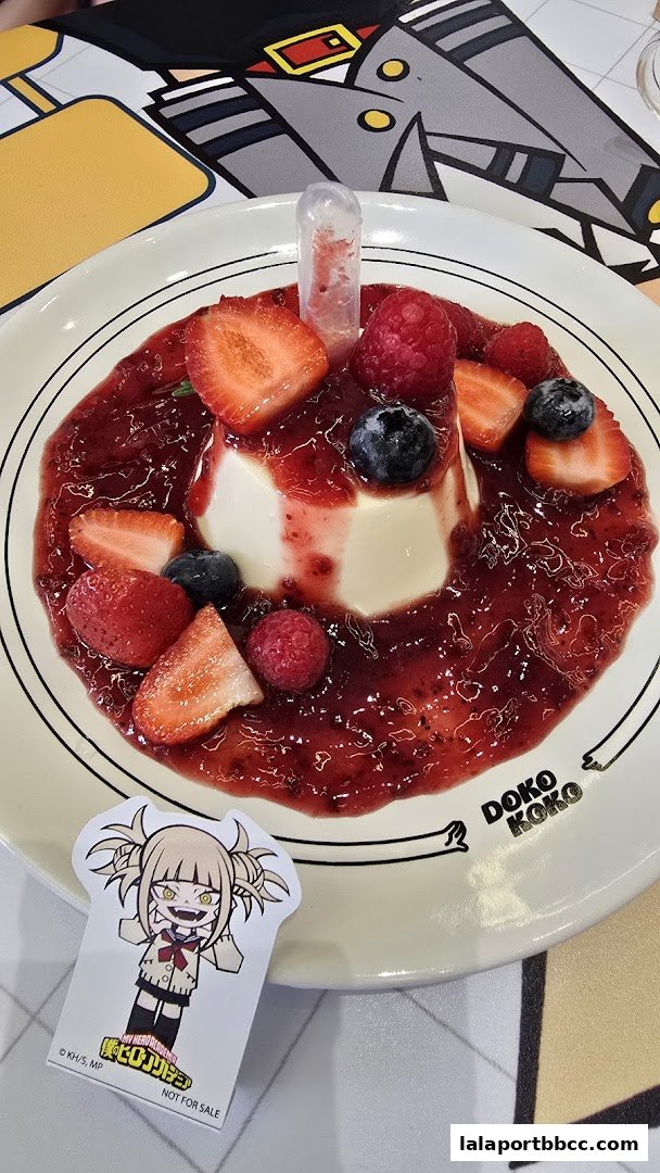 A delicious dessert with berries and a character sticker from Doko Koko.