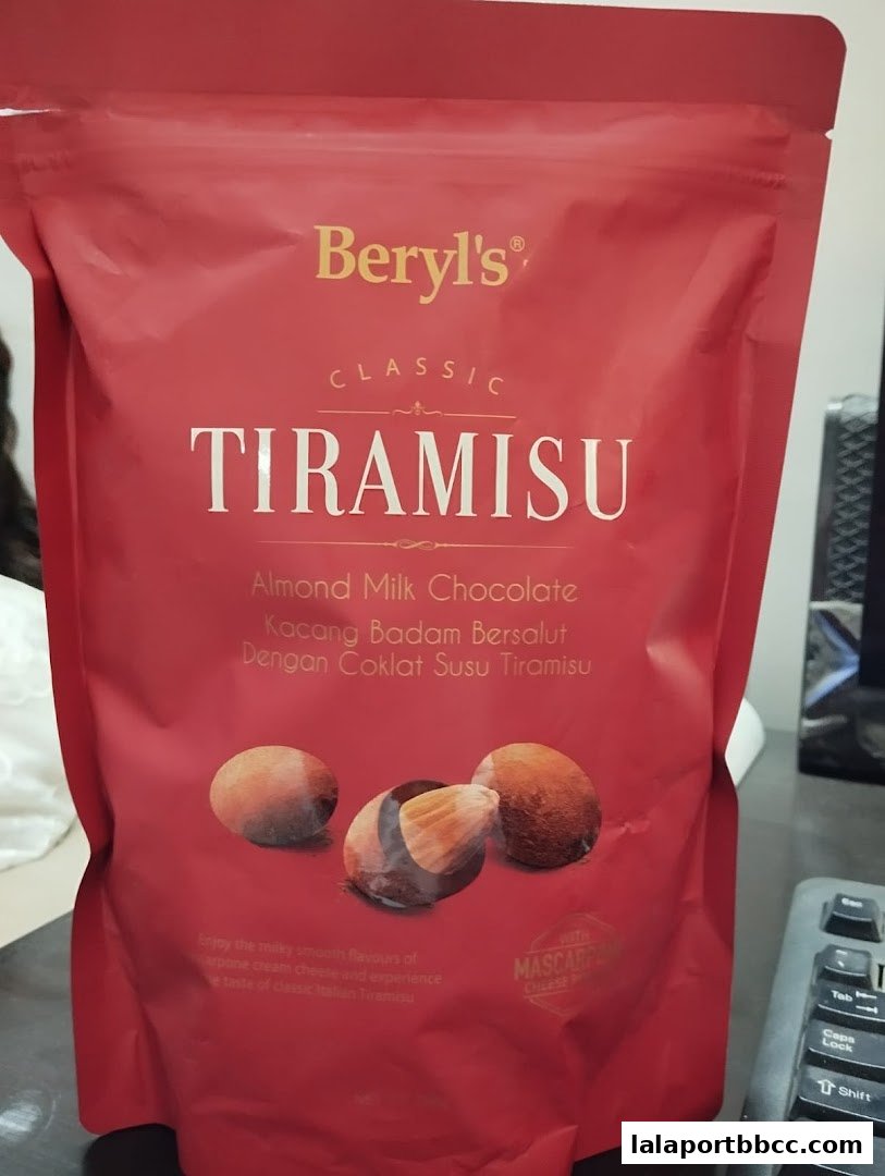 A red pouch of Beryl's Classic Tiramisu Almond Milk Chocolate with images of chocolate-covered almonds.