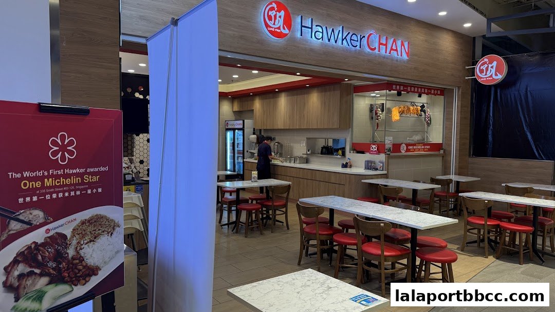 The entrance and dining area of Hawker Chan, a restaurant with a Michelin star award displayed.