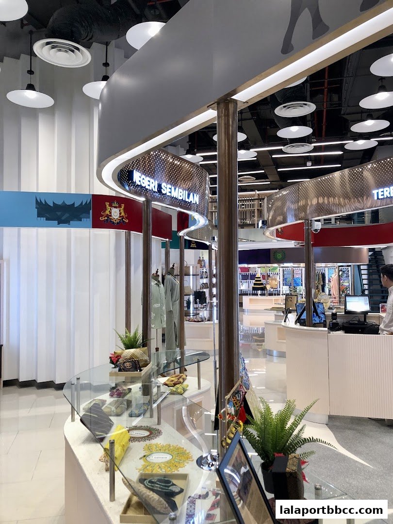 Interior view of a modern retail store showcasing traditional Malaysian crafts and clothing.