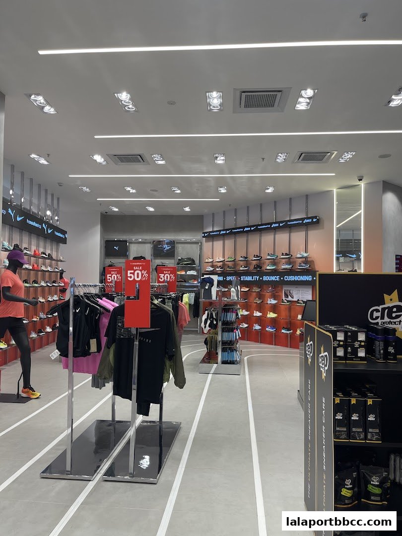 Interior of a sports apparel store with shoes and clothing displayed.