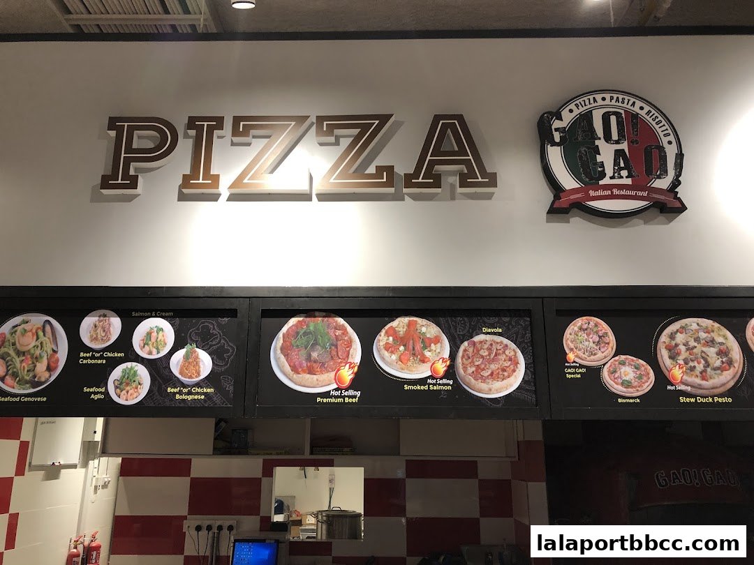 A food court display featuring pizzas and pasta dishes with enticing images and names.