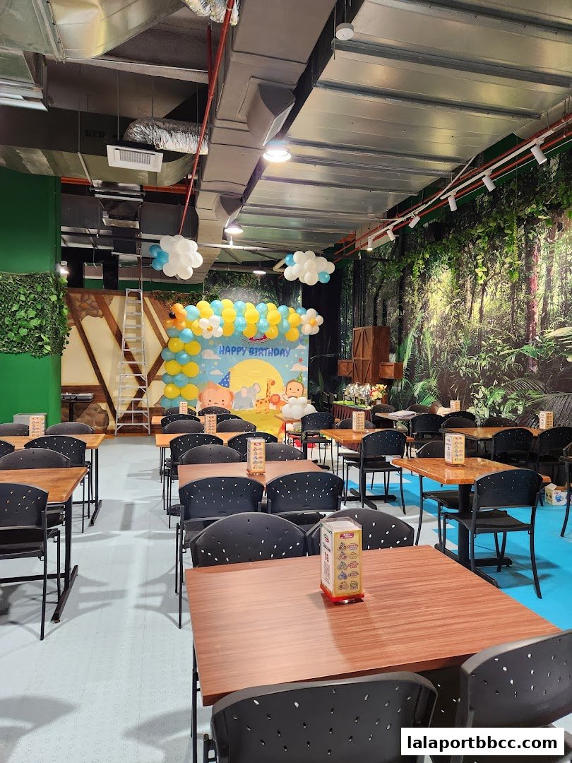 Interior of a restaurant with tables and chairs, decorated for a birthday party.