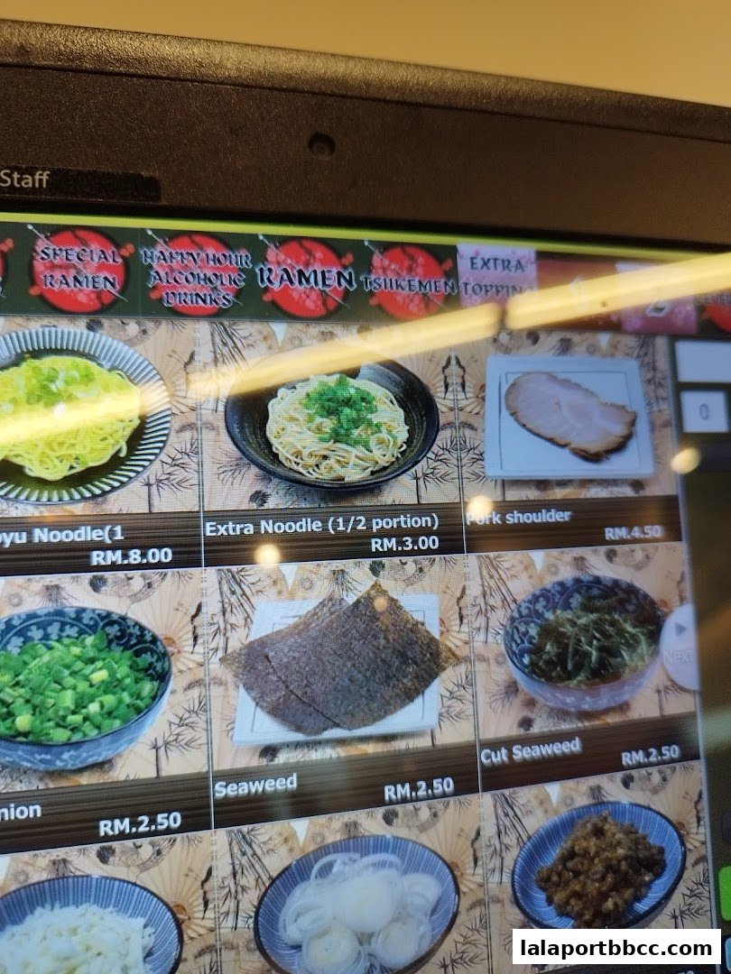 A digital menu displaying various ramen toppings and noodle options with prices.