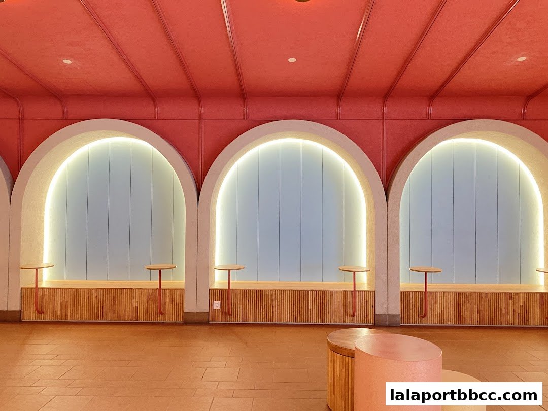 Interior shot of a stylish waiting area with arched alcoves and modern seating.