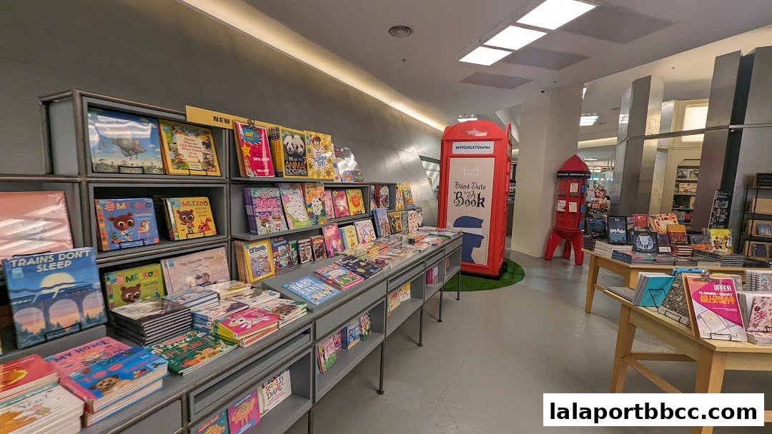 Interior view of a BookXcess store with shelves full of books and a red telephone booth display.