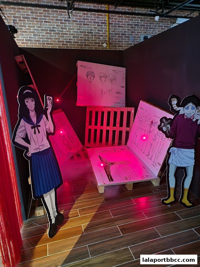 An immersive Junji Ito Horror House exhibit with character cutouts and eerie lighting.
