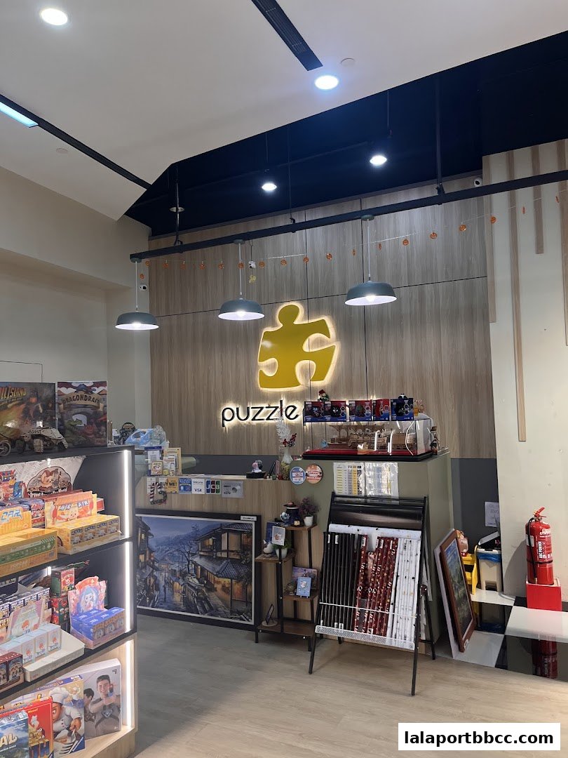Interior view of a puzzle shop showcasing various puzzles and framed artwork.