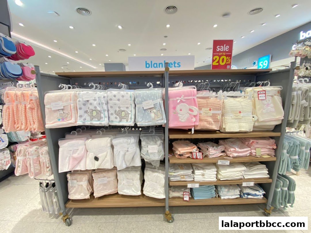Shelves filled with baby blankets and other soft goods in various colors and patterns.