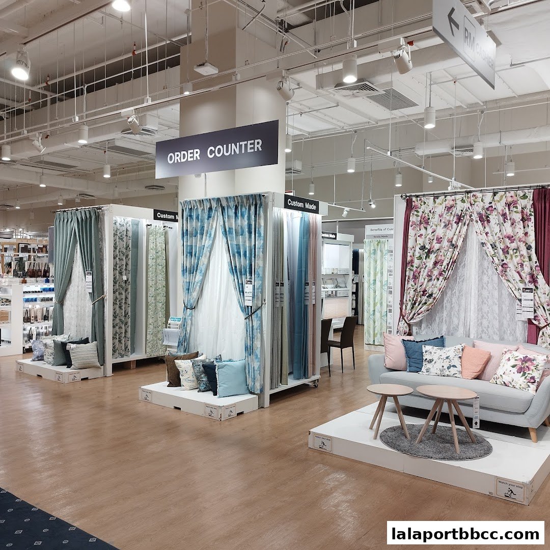 Interior view of a NITORI store showcasing various curtains and home decor items.