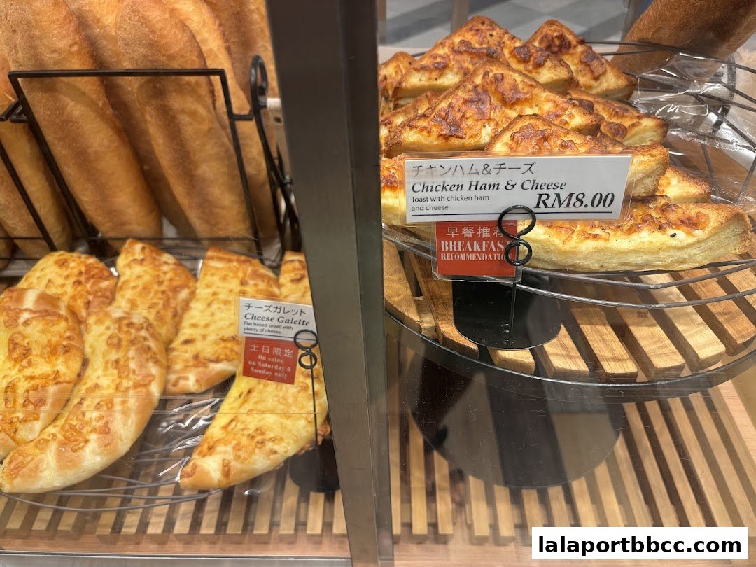 A display of freshly baked bread and savory pastries at DONQ Mini One.