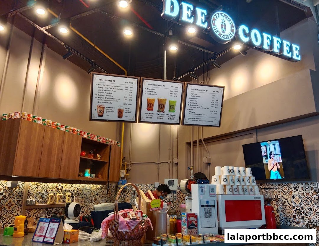 A menu board displaying various coffee and non-coffee drinks at Dee Coffee.
